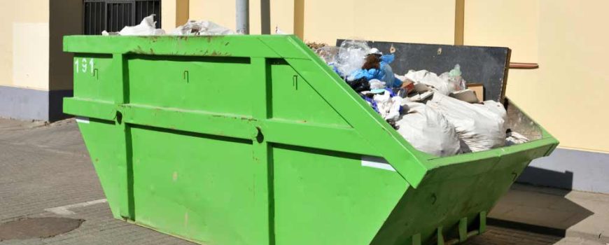 Green Skip On The Street Collecting Community Waste