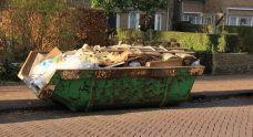 loaded dumpster in home renovations site