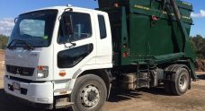 Truck With A Green Skip Bin