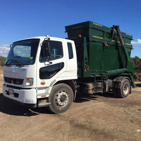 Truck With A Green Skip Bin