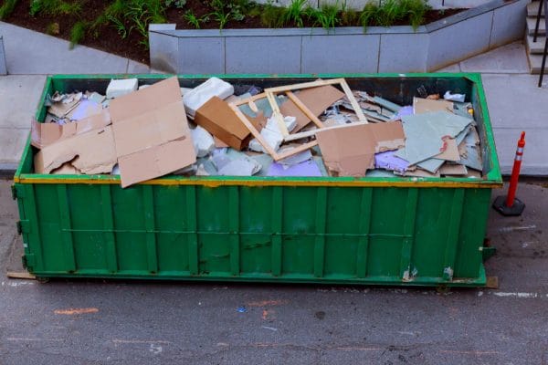 A pile of scraps and trash in a garbage bin